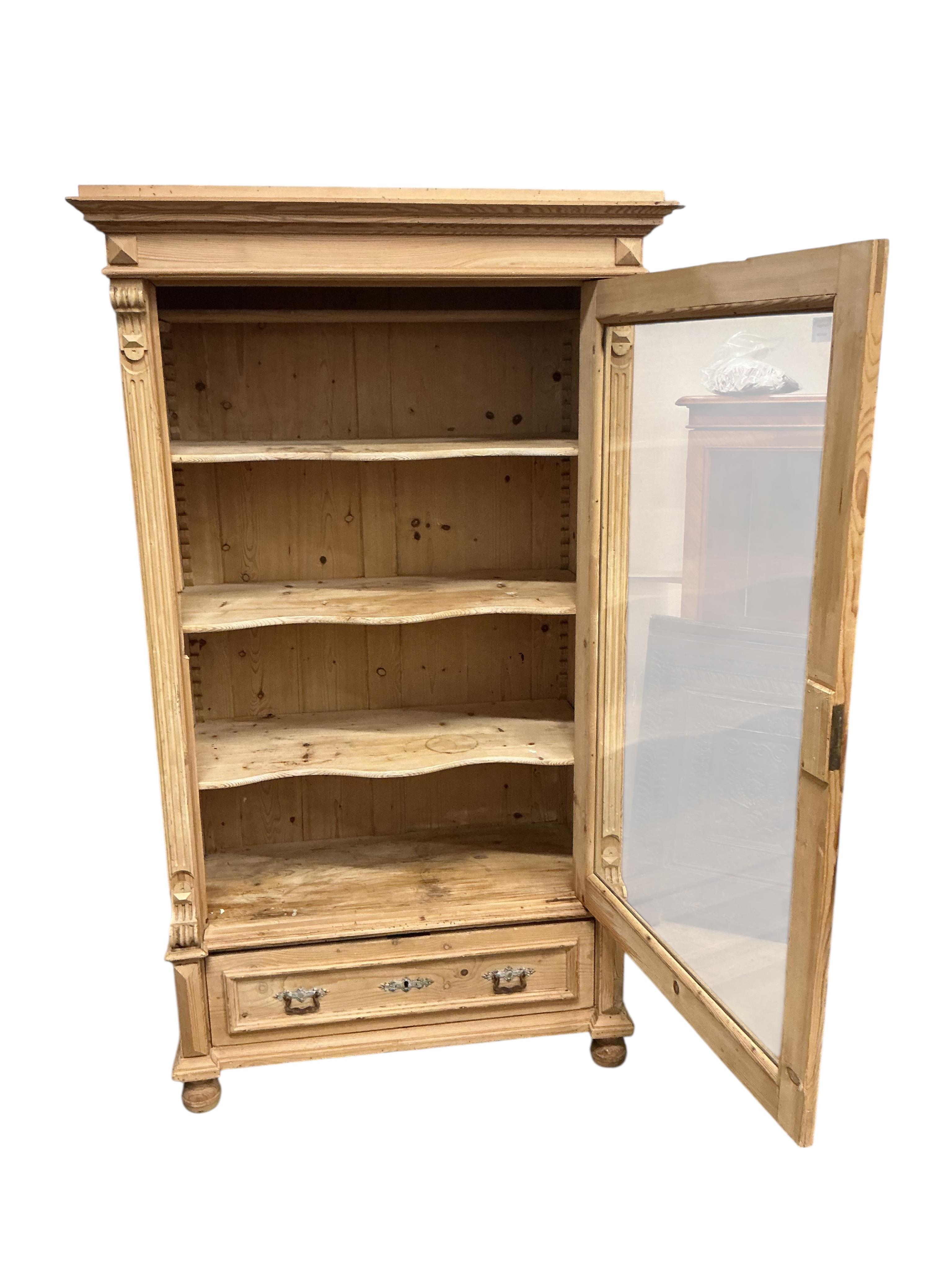 A 19th century East European glazed pine armoire, width 105cm, depth 56cm, height 182cm